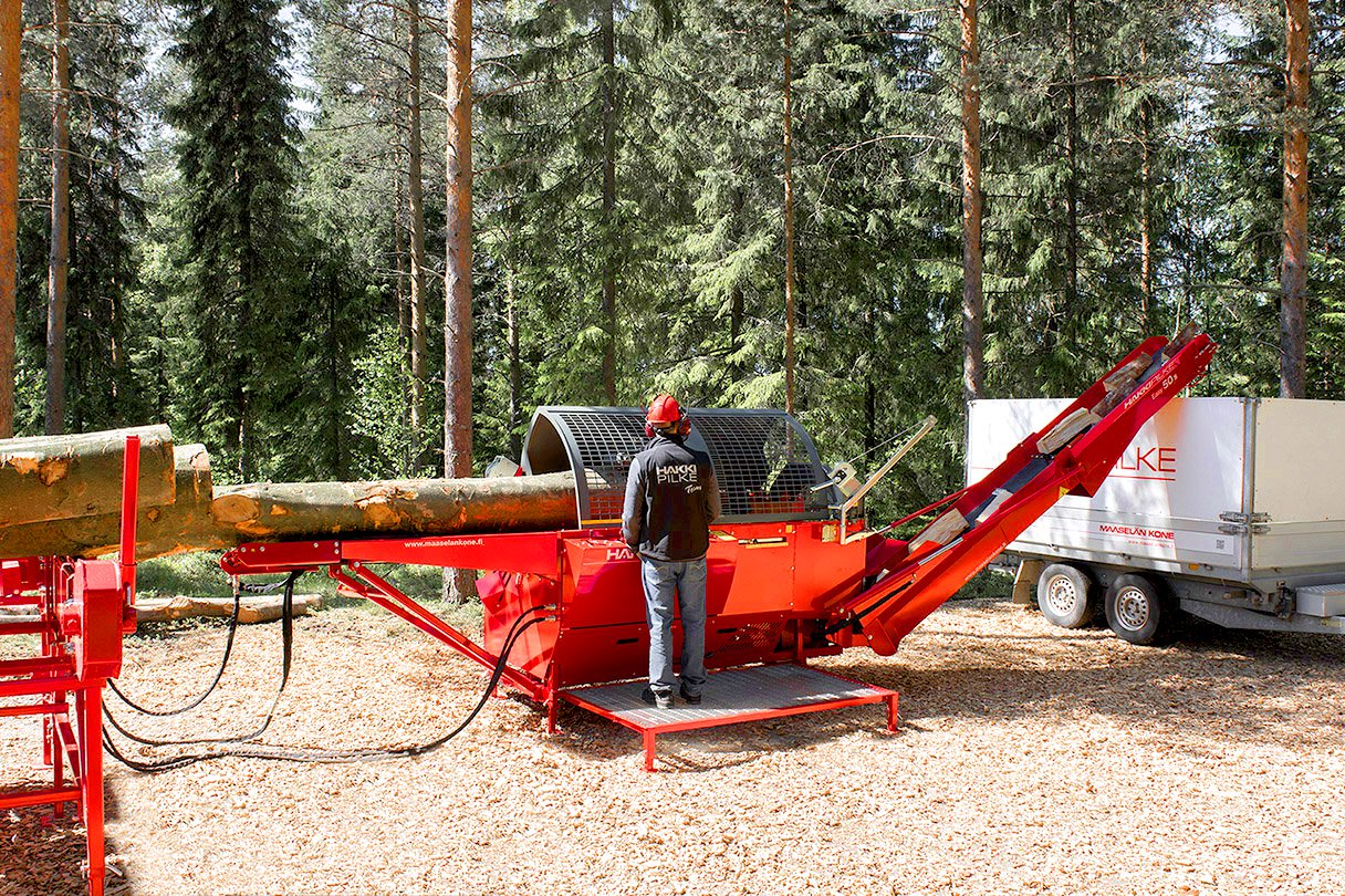 Operator producing firewood in a forest